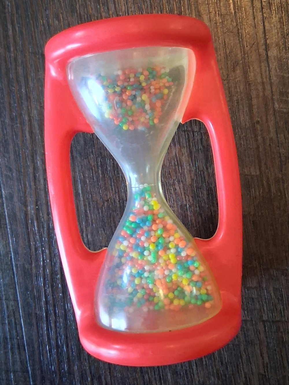 vintage Playskool or Fisher-Price hourglass baby rattle from the 1970s